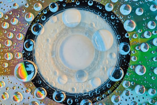 Image of Bright white center ringed by black with metallic shimmering metal and water droplets abstract asset