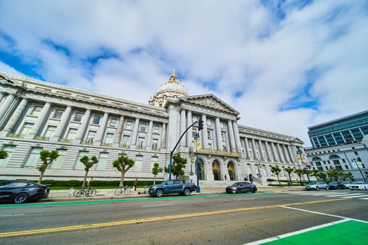 Image of Cars and bicycles parked along street in front of San Francisco city hall