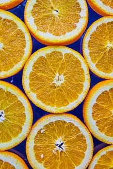 Image of Close up of orange slices on navy blue background