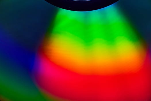 Image of Curving rainbow colored light on dark background asset
