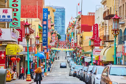 Image of Pedestrians and cars on vibrant and colorful Chinatown streets in San Francisco