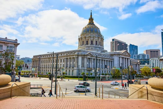 Image of City hall side view from red brick walkway leading to steps and government building across street