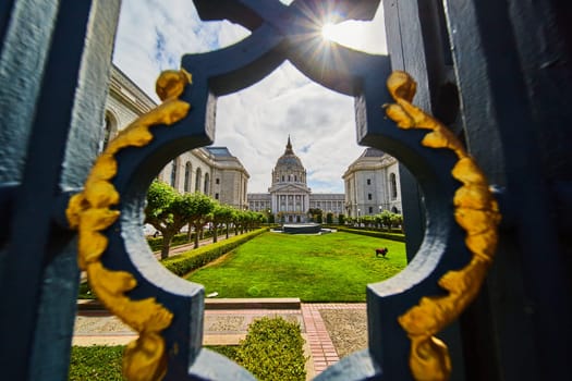 Image of Abstract view of courtyard and city hall through fancy black and golden gilded lamppost