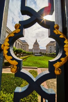 Image of Framed view of courtyard and city hall through fancy black and golden gilded lamppost