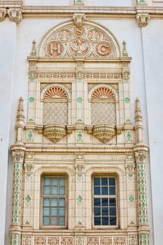 Image of Close up of fancy golden and pastel green elaborate wall and windows of city hall building