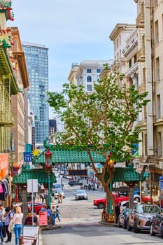 Image of Inside Chinatown San Francisco with tree growing beside iconic green roofed entrance