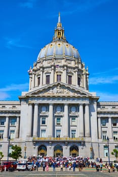 Image of Crowd gathering in front of San Francisco city hall on blue sky day