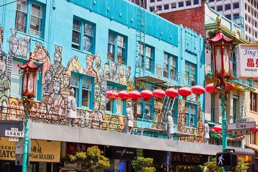 Image of Chinese building mural along clay street with red paper lanterns and soldier statues in chinatown