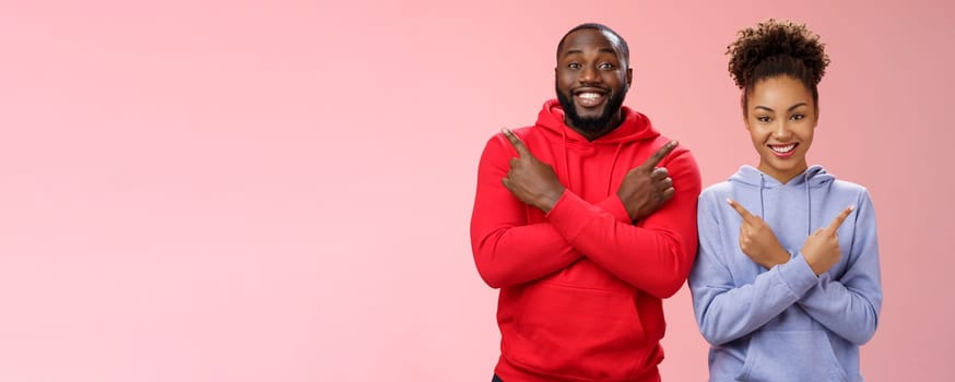 Lifestyle. Charming happy couple african american boyfriend girlfriend move in together pointing different sides cross arms chest left right smiling broadly upbeat have variety good choices opportunities.