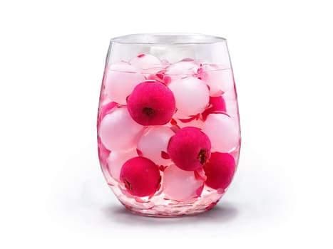 Lychee soda in a round glass whole lychees and rose petals exotic and sweet gentle. Drink isolated on transparent background.