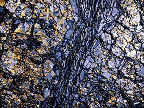 Stone isolated on transparent background. Schist A silvery schist stone with shiny mica inclusions floating and backlit to show off.