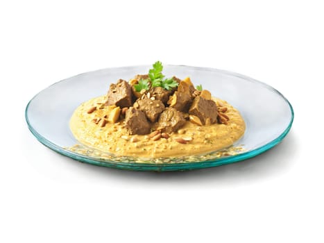 Lamb Korma with a creamy almond sauce served on a transparent glass plate mild. Food isolated on transparent background.