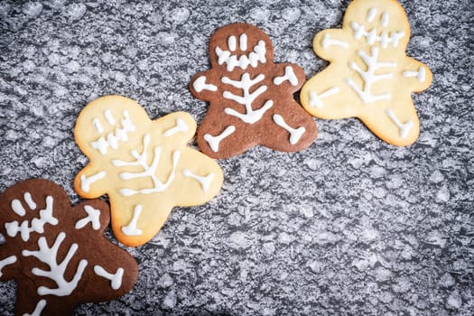 Chocolate and vanilla cookies in a Halloween theme, on a grey background.