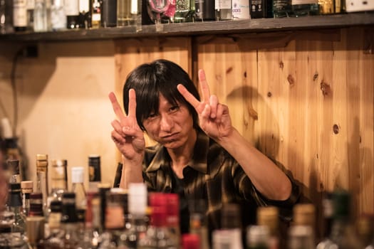 TOKYO, JAPAN - MAY 12, 2019 - People in bars in Golden-Gai district in Shinjuku, central Tokyo, Japan