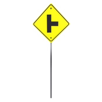 A yellow T-intersection sign stands on a pole, guiding drivers for upcoming turns.