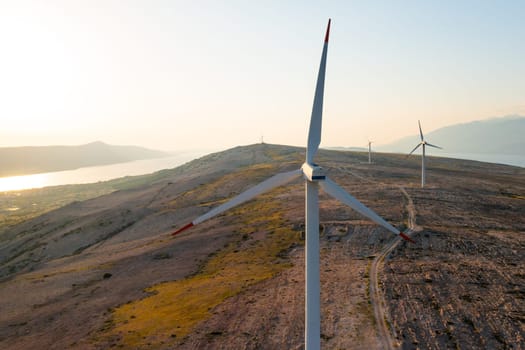 Modern wind turbines rotate generating clean energy on Pag Island. Innovative solution provides cost-effectiveness of wind energy in Croatia