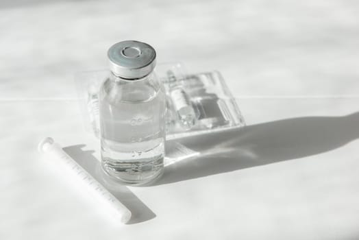 Coronavirus vaccine concept: covid-19 vaccine on white table