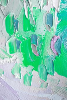 Thick layers of paint create a dynamic texture with various hues of green and pastel shades, capturing the essence of abstract art in bright daylight.