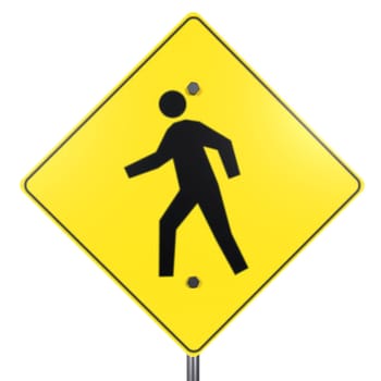 A vibrant yellow pedestrian warning sign with a human figure depicted walking.