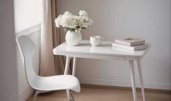 A white desk with a white chair is near a window and in front of a tan curtain. A white vase with white flowers sits on the desk. The desk also has a white mug and two books stacked on it.