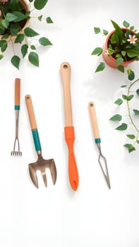 A set of gardening tools including a trowel, cultivator, hand rake, and a weeder are neatly placed on a table, surrounded by vibrant potted plants in bright, natural light.