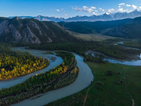 Kurai steppe and Chuya river on North-Chui ridge mountains background. Altai mountains, Russia. Aerial drone panoramic picture.