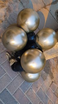 inflatable gold balloons on the ground, fence street objects. High quality photo