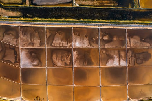 Salt pans divided into sections with seawater on Pag Island. High-quality sea salt production using traditional and safe methods in Croatia