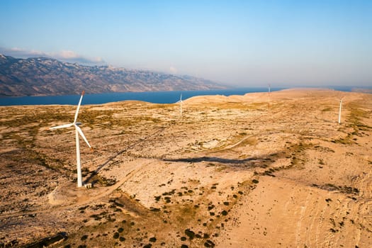 Innovative wind turbines rotate generating clean energy on Pag Island at twilight. Modern technology provides sustainable source of power in Croatia
