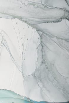 The surface features a stunning marbled design with gentle gray and white hues, exhibiting flowing patterns that evoke a sense of tranquility and refined elegance.