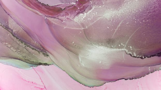 Vibrant fluid art combines shades of purple and pink, creating mesmerizing patterns with delicate textures. The flowing colors evoke a sense of tranquility and creativity.