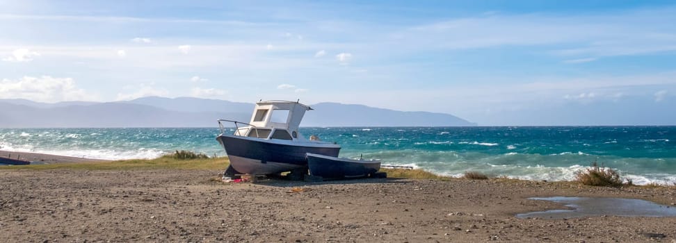 Conceptual view of the lonely boat on the sea beach