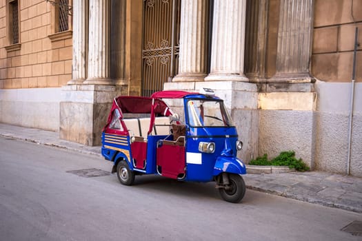 A traditional ape taxi on the streets of Palermo, Italy.
