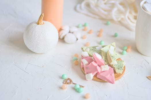 High angle view of pastel colored candy and festive decor with soft tones, creating a cozy ambiance.
