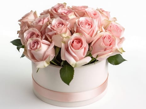 A stunning display of soft pink roses arranged elegantly in a round white box, accented by fresh green leaves, ideal for celebrations or heartfelt gifts.