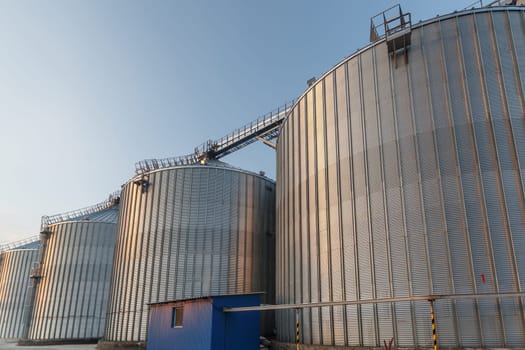 Panoramic view of industrial silos and grain storage facilities at sunset. elevator, grain storage facility