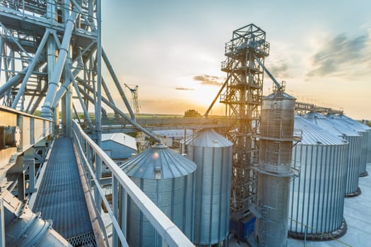 Panoramic view of industrial silos and grain storage facilities at sunset. elevator view from above, grain storage facility