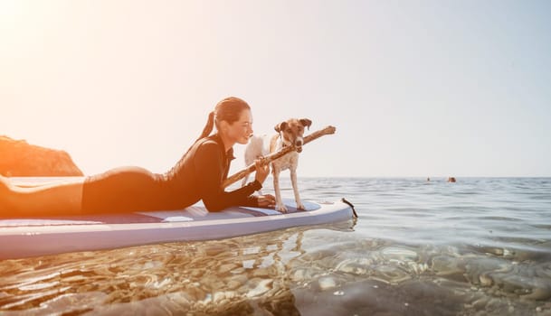 Sea woman sup. A happy positive woman in hat with family relaxing in sea, aerial back view of family on SUP board floating on calm water. Active lifestyle at sea. Summer vacation. Slow motion