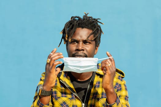attractive young african man wearing a protective mask, lifestyle concept and virus protection