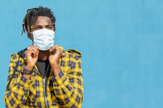 attractive young african man wearing a protective mask, lifestyle concept and virus protection, copy space for text