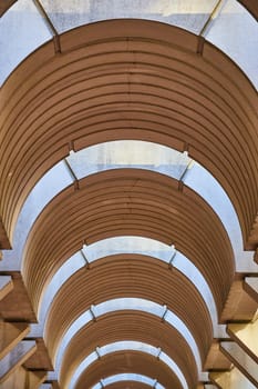 Image of Symmetrical tunnel ceiling with optical illusion openings for sunlight