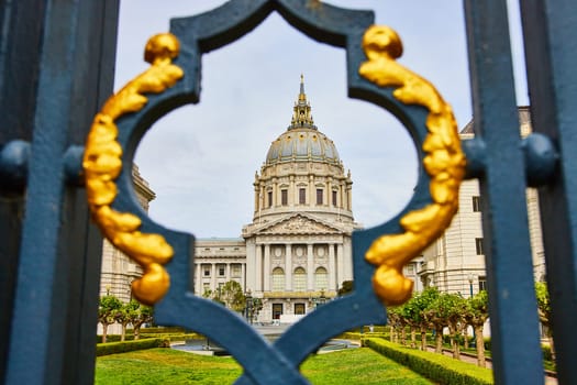 Image of Abstract view of memorial court and city hall through fancy black and golden gilded lamppost