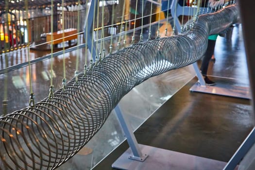 Image of Metal rings making long slithering tunnel in science experiment