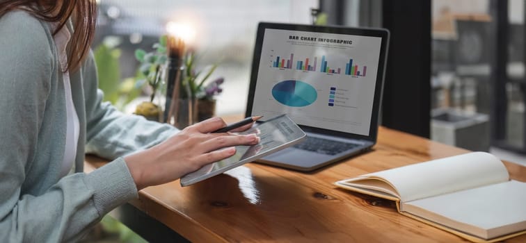 Young accountant calculates taxes, expenses and finances with results in graph form for readability..