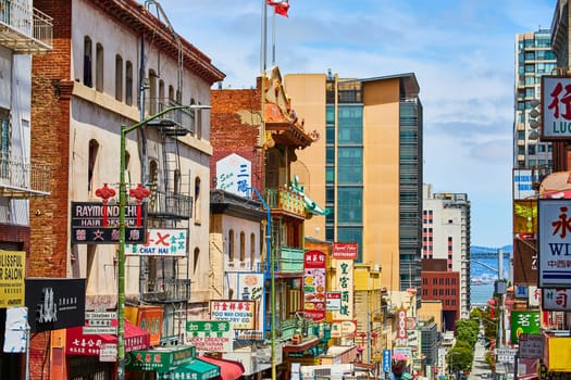 Image of Chinatown street view of shop signs leading down street toward San Francisco Bay