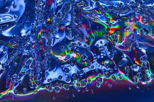 Image of Vibrant abstract art with rainbow colors in bubbles flowing across wavy oily surface background