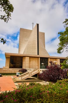 Image of Plants and flowers framing distant Cathedral of Saint Mary of the Assumption entrance exterior