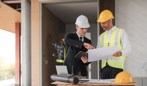 Diverse Team of Specialists Use Laptop on Construction Site. Real Estate Building Project with Engineer Investor and Businessman Checking Area, working on Civil Engineering, Discussing Strategy Plan.