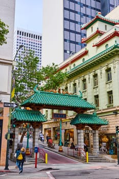 Image of San Francisco elaborate Chinatown entrance with pedestrians and shops