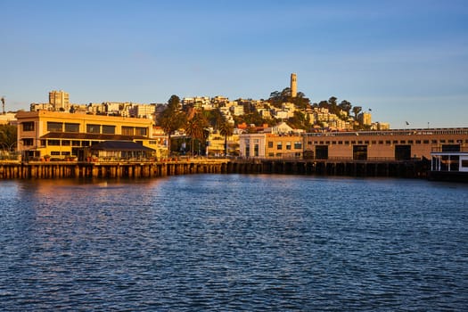 Image of San Francisco Bay view looking at shoreline and Coit Tower near sunset and golden hour